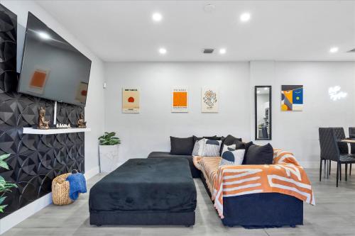 a living room with a couch and a bed at 5 min to Brickell & Bars - Arcade - King Bed - Outdoor Fun in Miami