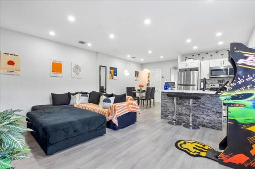 a living room with a couch and a kitchen at 5 min to Brickell & Bars - Arcade - King Bed - Outdoor Fun in Miami