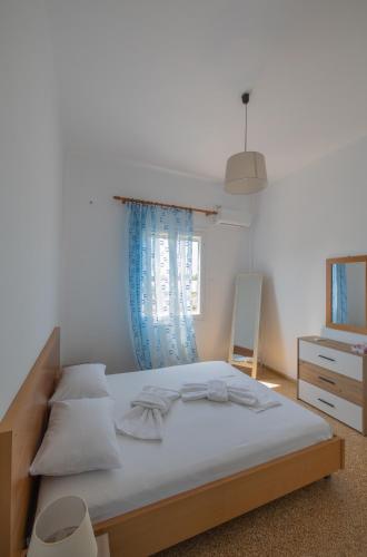 a bedroom with a large bed with a blue curtain at Classic Guesthouse Nafplion in Nafplio