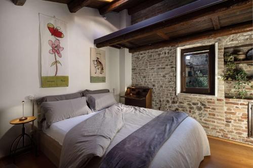 Postel nebo postele na pokoji v ubytování Al Paese Vecchio - Boutique house nel cuore del borgo