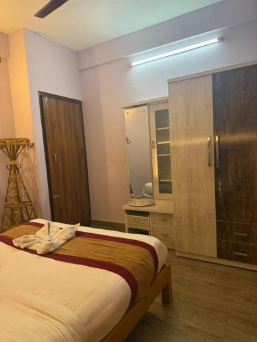 a bedroom with a bed and a dresser with a mirror at Hotel sunrise heaven in Pokhara