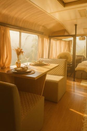 a table with a wine glass on it in a rv at Refúgio Da Lua - Buss motorhome in Ametista do Sul