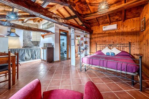 a bedroom with a bed in a room with wooden walls at Casa Puggimiano in Poggio Moiano