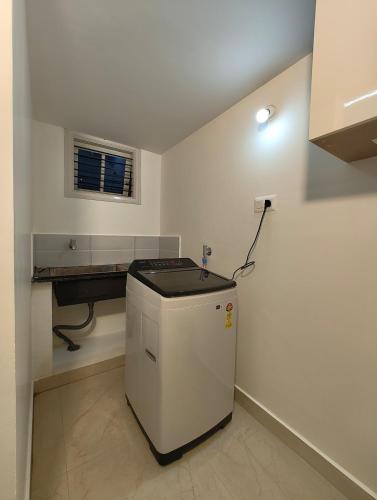 a kitchen with a small refrigerator in a room at Homestay 2BHK, 3BHK, 4BHK, 5BHK call 8O8823-7972 in Narasimharaja Puram