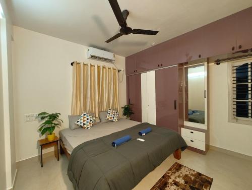 a bedroom with a bed and a ceiling fan at Homestay 2BHK, 3BHK, 4BHK, 5BHK call 8O8823-7972 in Narasimharaja Puram