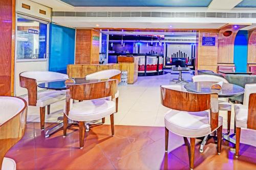 a restaurant with tables and chairs and a bar at Hotel Claytone Near Delhi Airport in New Delhi