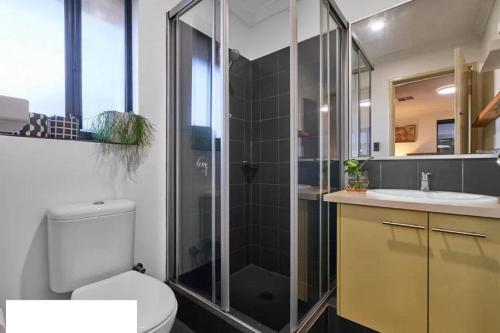 a bathroom with a shower and a toilet and a sink at Spearwood Little Getaway in Spearwood