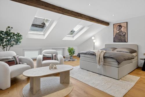 a bedroom with a bed and a table at 3 Queen Beds Waterfall Garage Terrace Center in Saarburg