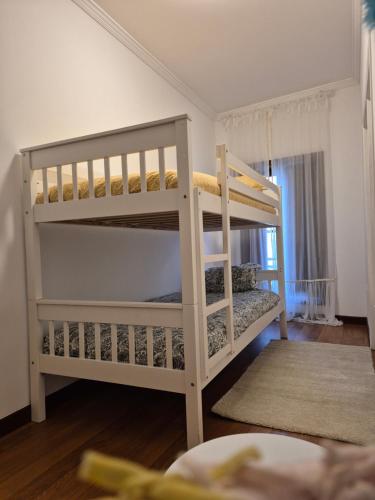 a bedroom with two bunk beds in a room at A casa do cervo in Vila Nova de Cerveira