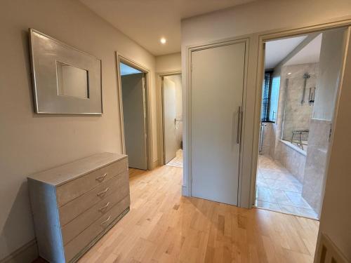 a bathroom with a dresser and a walk in shower at Spacious 3-bed in Dulwich with parking in West Dulwich