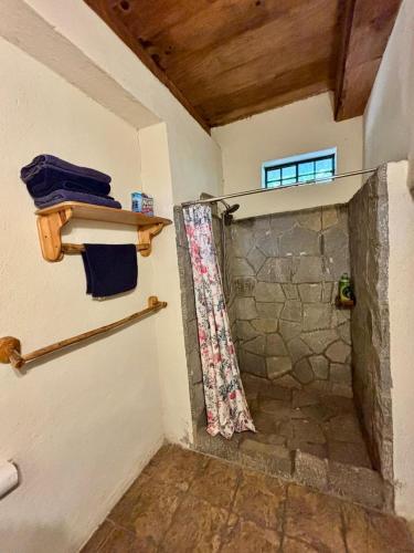 a bathroom with a shower with a shower curtain at Paradise of Atitlan in Santiago Atitlán