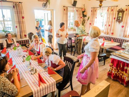 a group of people sitting at tables in a restaurant at Siri's Einkehr in Sankt Georgen im Attergau
