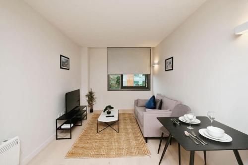 a living room with a couch and a table at Modern 1 Bed Apt Bracknell- with parking in Bracknell