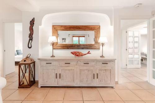 a white room with a vanity with a mirror at Villa Tesoro, El Toro, South West Mallorca in El Toro