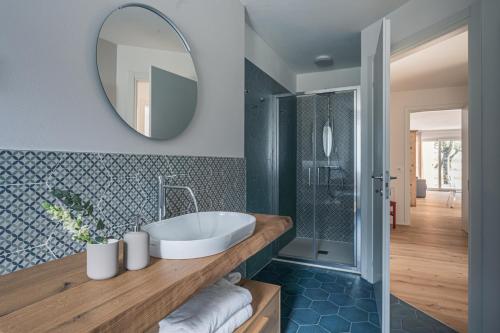 a bathroom with a sink and a mirror at iFlat Pinzolo Apartment Gufo in Pinzolo