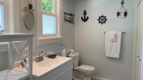 a white bathroom with a sink and a toilet at Sandy Shores in Union Pier