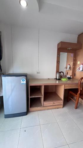 a kitchen with a table and a refrigerator at Smile room 21 in Patong Beach