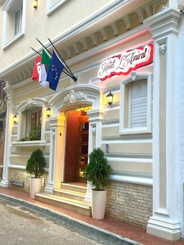a restaurant with flags on the front of a building at Amirale in Oran