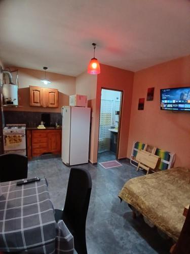 a kitchen with a white refrigerator and a table at Monoambiente San Bernardo in San Bernardo