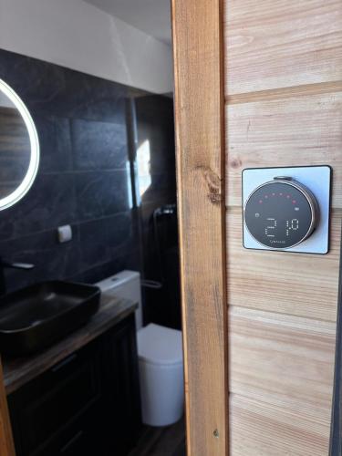 a door to a bathroom with a sink and a toilet at Transilvania Chalet in Zărneşti