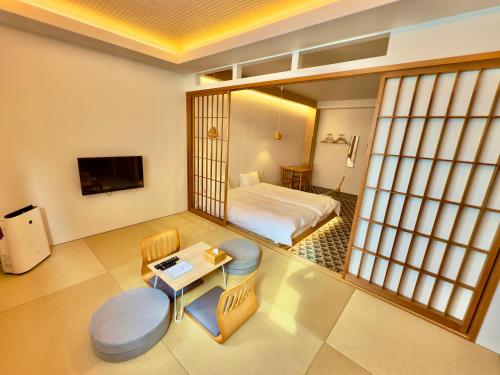 a hotel room with a bed and a table at Hotel Imagine Kyoto in Kyoto