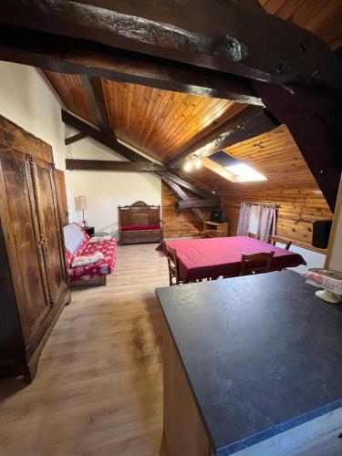 a living room with a table and chairs in a building at Gîtes de la Ferme Basso in Planès