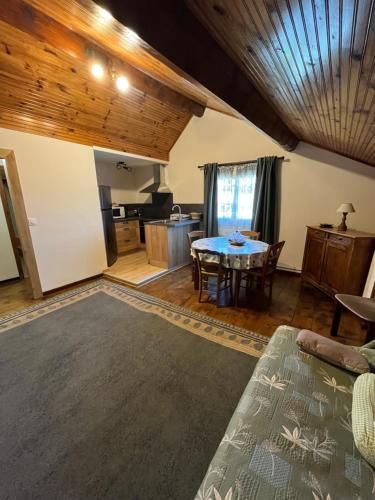 a living room with a table and a kitchen at Gîtes de la Ferme Basso in Planès