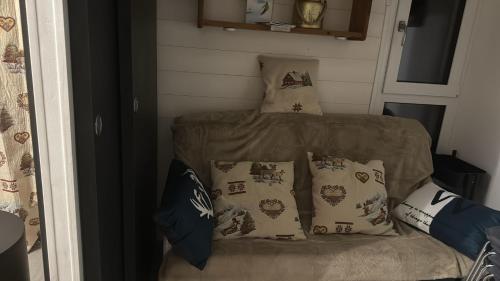 a small bed in a room with pillows at LE GL'ASSIE in Saint-Gervais-les-Bains
