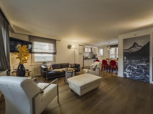 a living room with a couch and a table at Central & Elegant Apartments,partially with Fireplace, by Zermatt Rental in Zermatt
