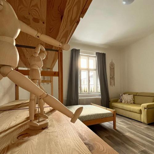 a room with a robot on a bed with a couch at Resident Rebels in Železná Ruda