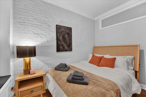 a bedroom with a bed and a lamp on a night stand at Gramercy Apartment - 3BR 2BA Modern Central in New York