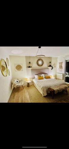 a bedroom with a large bed and two mirrors at Le côte d opale bohème plage in Calais