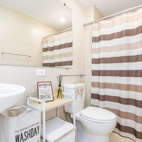 a bathroom with a toilet and a shower curtain at New Studio Boho Studio with PS4 & Balcony in San Fernando