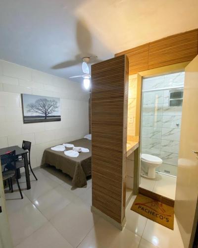 a small room with a bed and a bathroom at Pacheco Pousada in Sabará