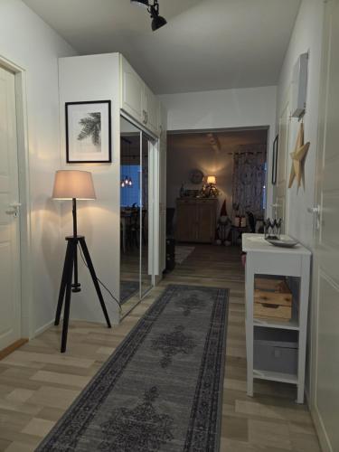a living room with a lamp and a table at Arctic Circle Home in Rovaniemi