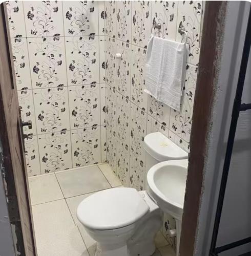 a bathroom with a toilet and a sink at Espaço completo no Umarizal centro de Belém in Belém