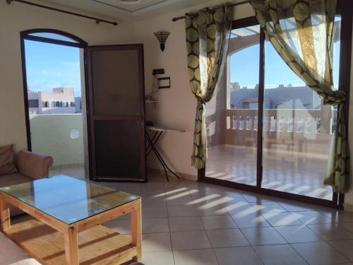 a living room with a view of a balcony at Modern villa with pool in Mirleft