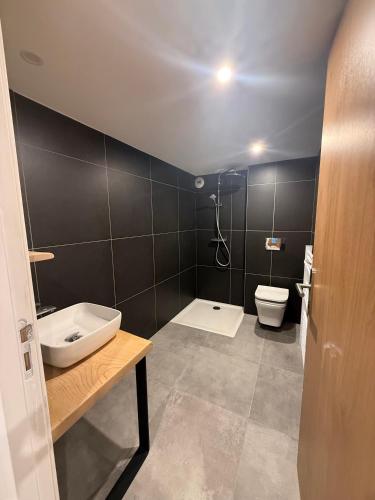a bathroom with a sink and a toilet in it at Le Touring Hôtel restaurant in La Celle-sous-Gouzon