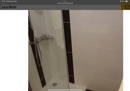 a shower with a glass door in a bathroom at Casa Bele Algarve in Ferragudo
