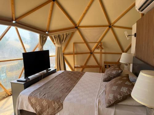 a bedroom with a bed and a large window at Lamoya Suites in Silifke