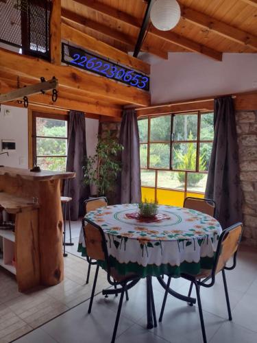 a dining room with a table and chairs and a piano at casavillaza in Necochea