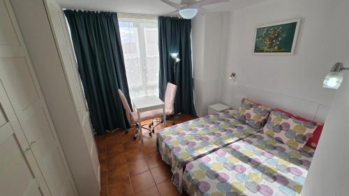 a small bedroom with a bed and a window at Tenerife near aeropuerto in San Isidro