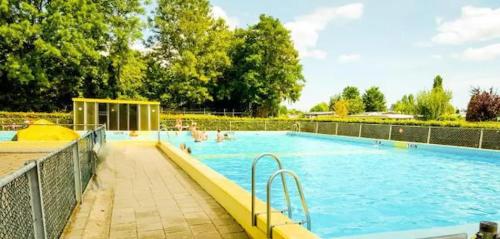 a large swimming pool with people in the water at 3 bedrooms Family House till 6 p Near Amsterdam & Sea in Opmeer
