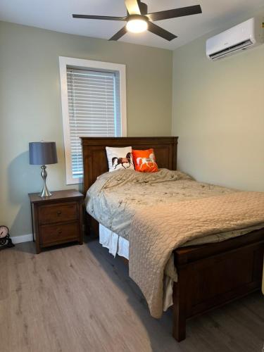 a bedroom with a bed and a ceiling fan at Hudson Valley Top Getaway with a River View in Newburgh