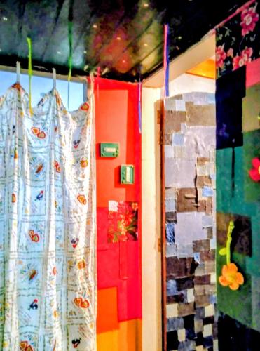 a room with colorful walls and curtains on the wall at há uma bela casa in Ubatuba