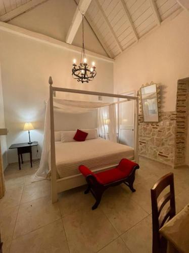 a bedroom with a bed and a chandelier at Casa Heredia Boutique in Cartagena de Indias