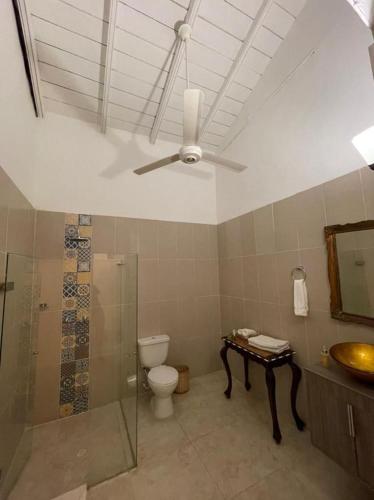 a bathroom with a toilet and a ceiling fan at Casa Heredia Boutique in Cartagena de Indias