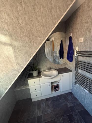a bathroom with a sink and a mirror at Coastal Nest in Margate