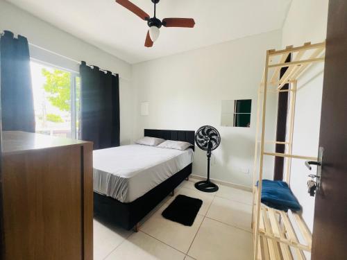 ein Schlafzimmer mit Bett und Deckenventilator in der Unterkunft Residencial Passos 2 in Guaratuba