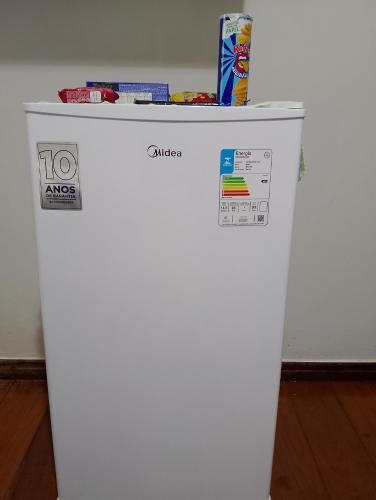 un frigorifero bianco con una scatola sopra di Pousada Solluar a Paracatu